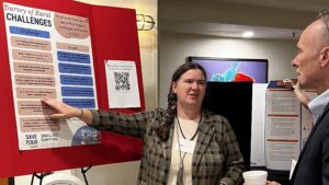 Becky McCray presents Survey of Rural Challenges to Dr Mark Balschweid of University of Nebraska Lincoln, at the Oklahoma State University Rural Renewal Symposium