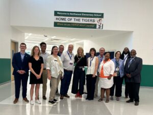 A diverse group tour a new school building in Baltimore, Maryland.